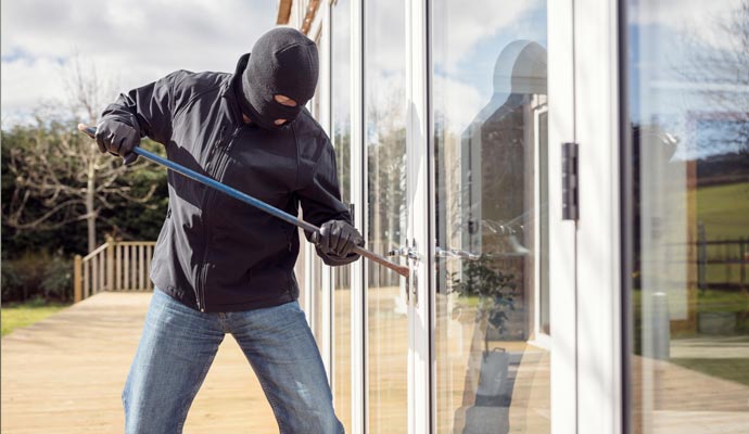 Burglar breaking glass door Burglar breaking glass door