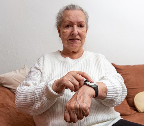 An elderly person using medical alert system An elderly person using medical alert system