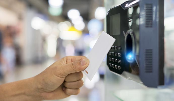 a person scanning their access card on an access control system