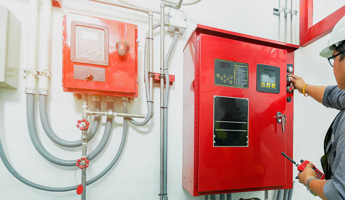 Professional worker maintaining fire alarm system