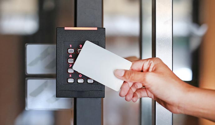 a person scanning their keycard on a keycard reader