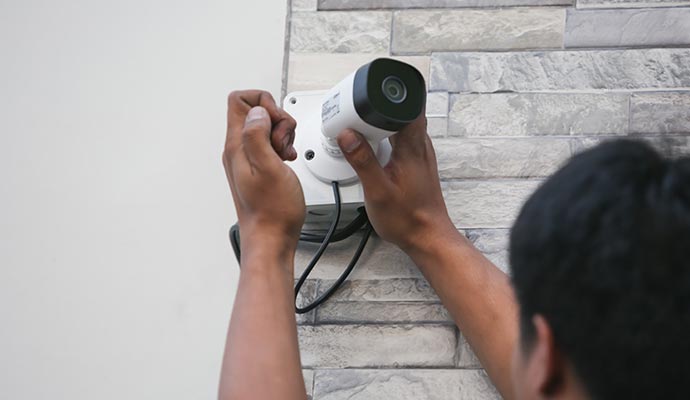 Person installing facial recognition camera