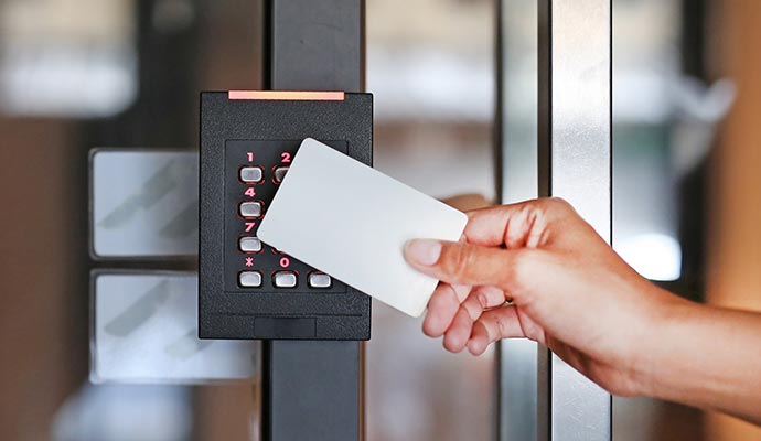 a person using a smart card to unlock a door