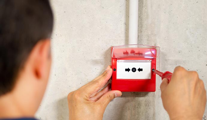 Person repairing fire alarm system