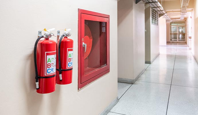fire extinguisher on the wall in an office hallway