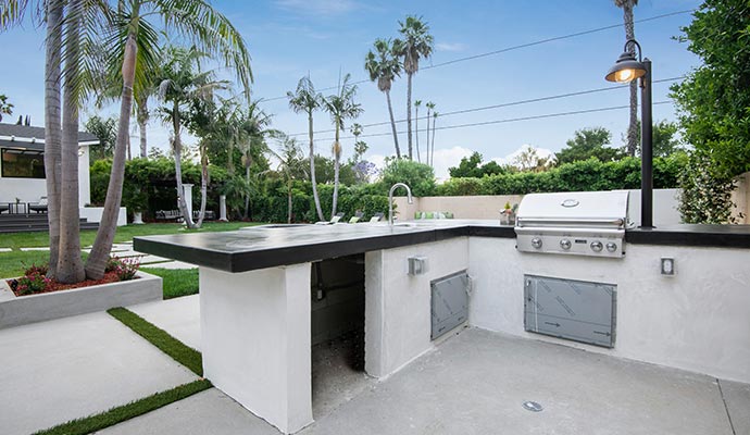 modern outdoor kitchen with a built-in grill