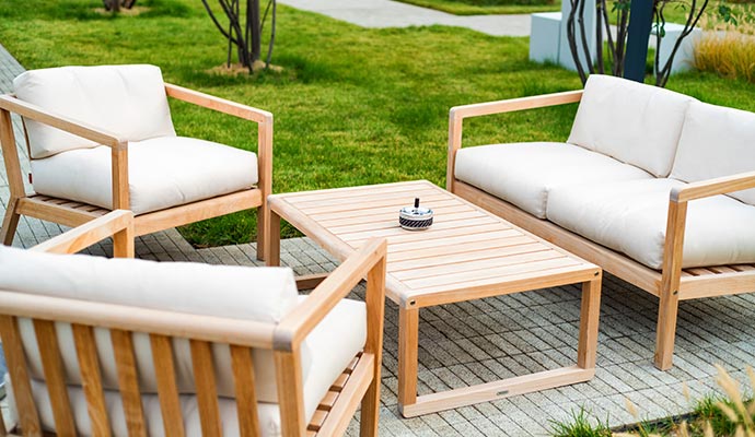 A stylish outdoor patio with comfortable seating, and a wooden table