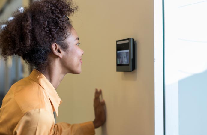  Image showing a woman using video verification system.